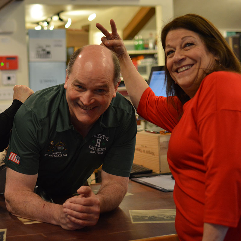 Hickey’s Wine & Spirits staff members playing around in a photo, including bunny ears gesture.