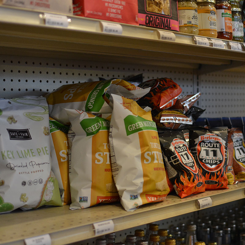 Snacks and party food on shelves that are available at Hickey's Wine & Spirits.